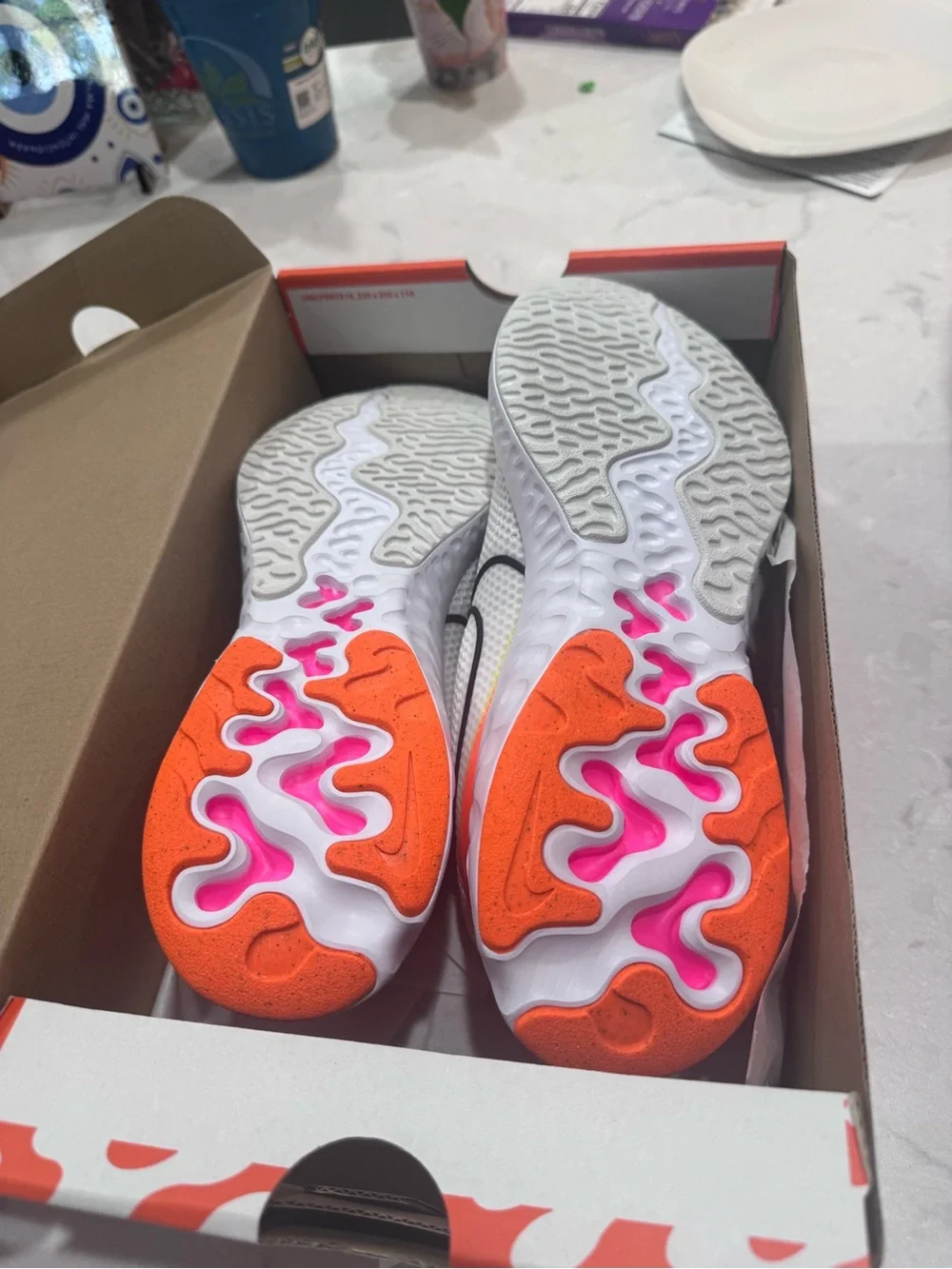 Nike White Running Shoe with Pink and Orange Accents